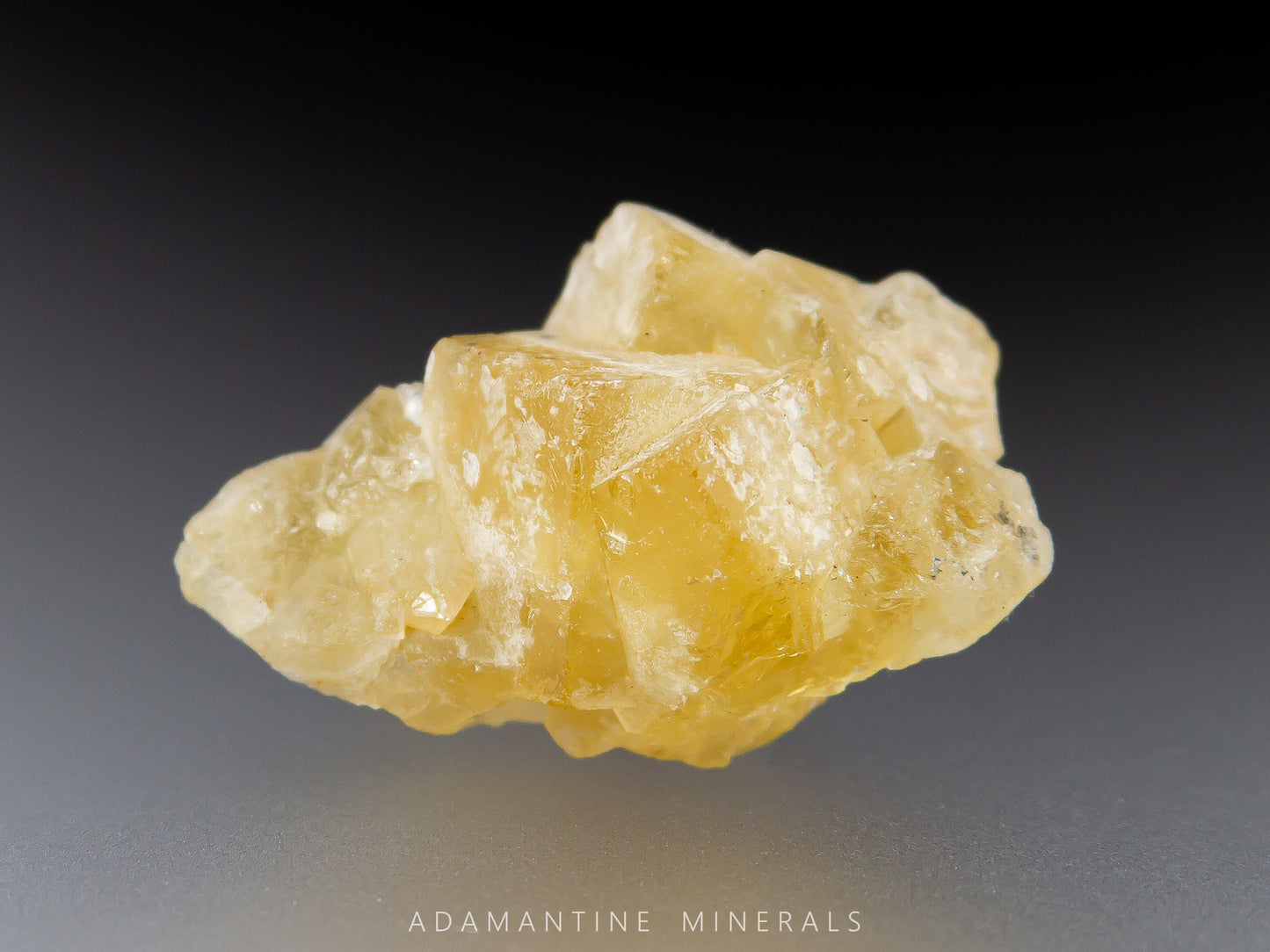 Yellow fluorite crystal cluster with cubic shape and earthy luster.