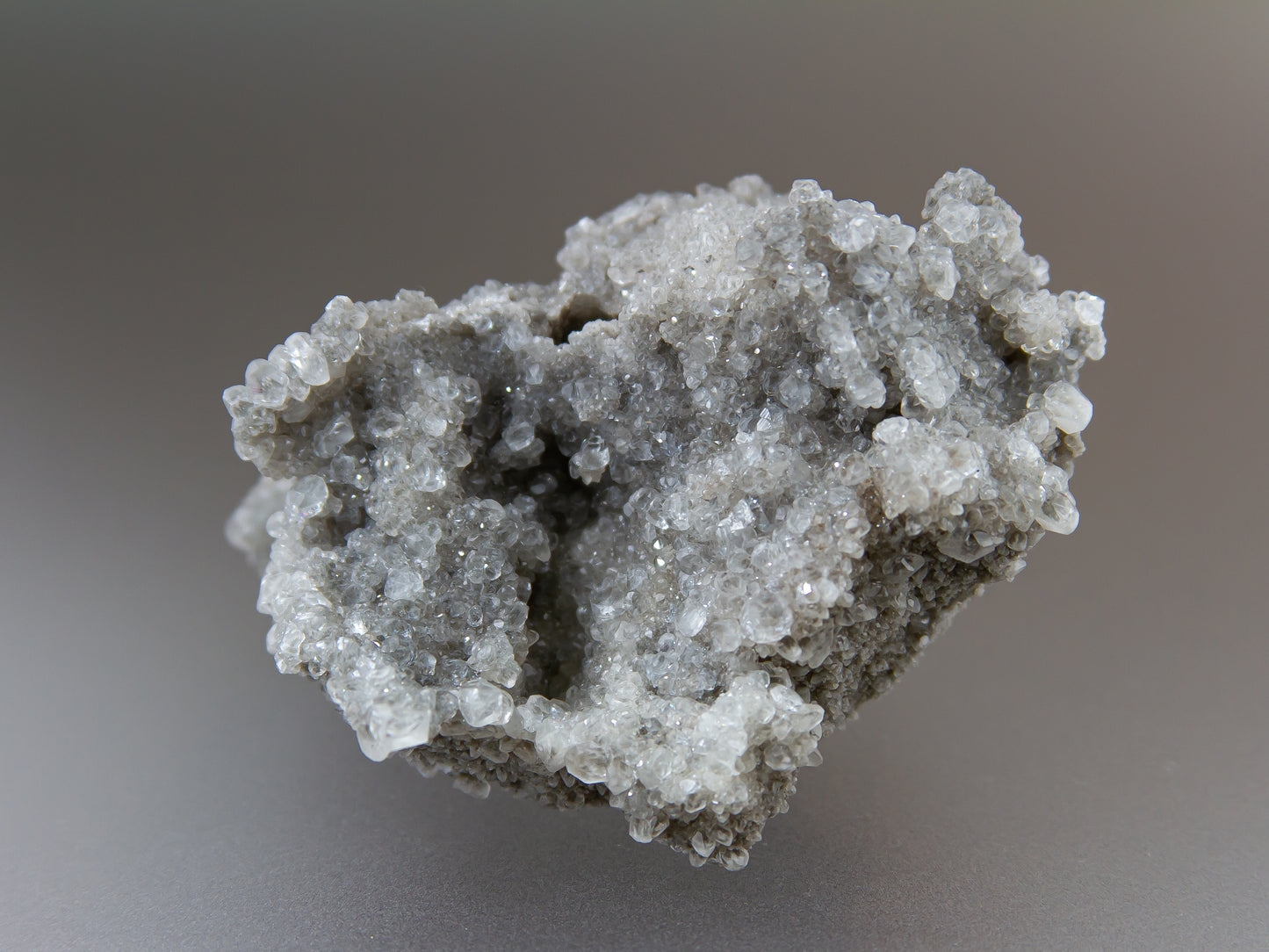 Close-up of a gray crystal formation on a blurred background