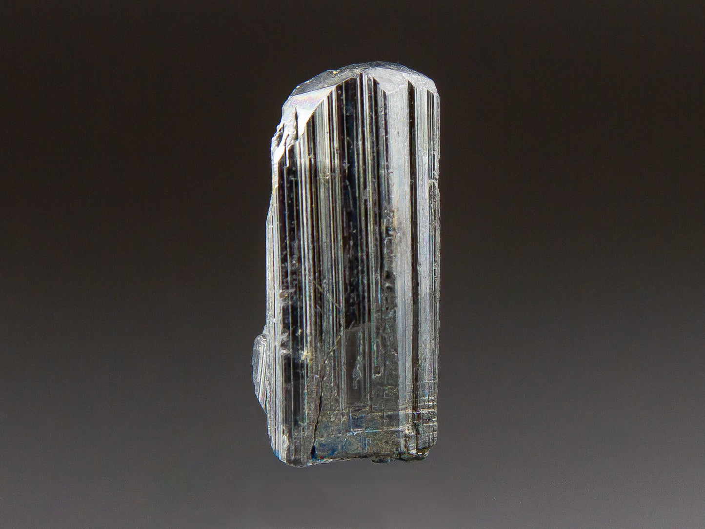 Crystal with layered structure on a dark background