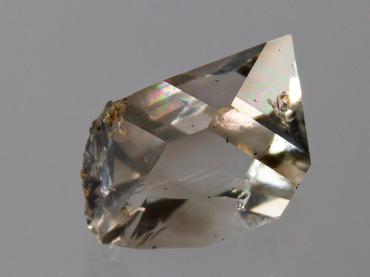 A lightly smokey doubly terminated Herkimer Diamond quartz specimen with excellent clarity and small inclusions of black hydrocarbons.