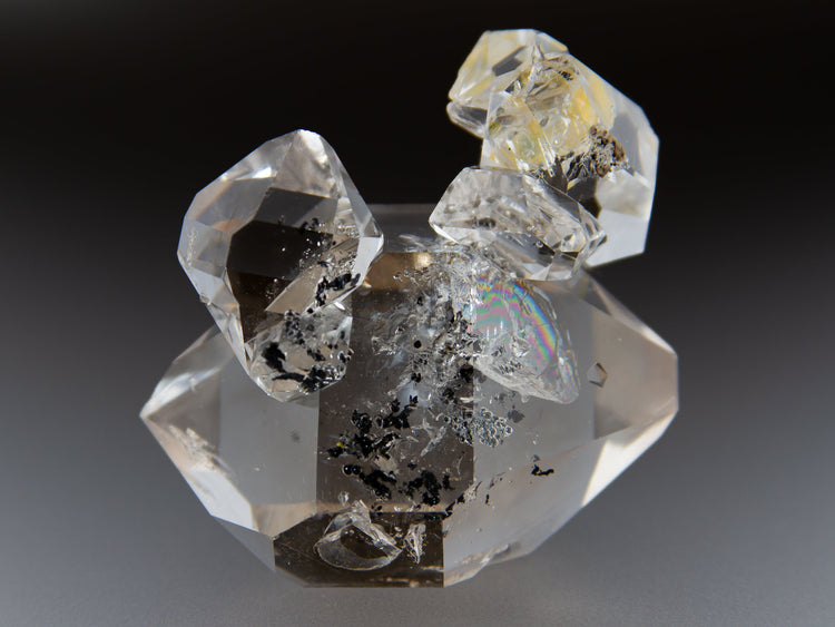 A large Herkimer Diamond quartz cluster with a larger double terminated crystal accented by several perched quartzes.