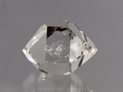 Water clear Herkimer Diamond quartz crystal with natural flat faces and excellent clarity. This raw mineral specimen has double terminations and small internal inclusions/negative crystals. Multifaceted shape makes it ideal for jewelry making or wire wrapping. 
