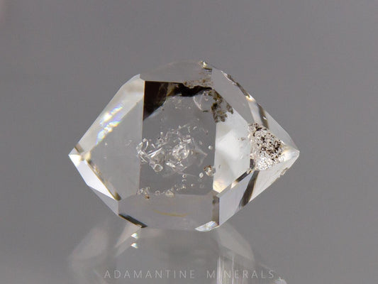 Water clear Herkimer Diamond quartz crystal with natural flat faces and excellent clarity. This raw mineral specimen has double terminations and small internal inclusions/negative crystals. Multifaceted shape makes it ideal for jewelry making or wire wrapping. 
