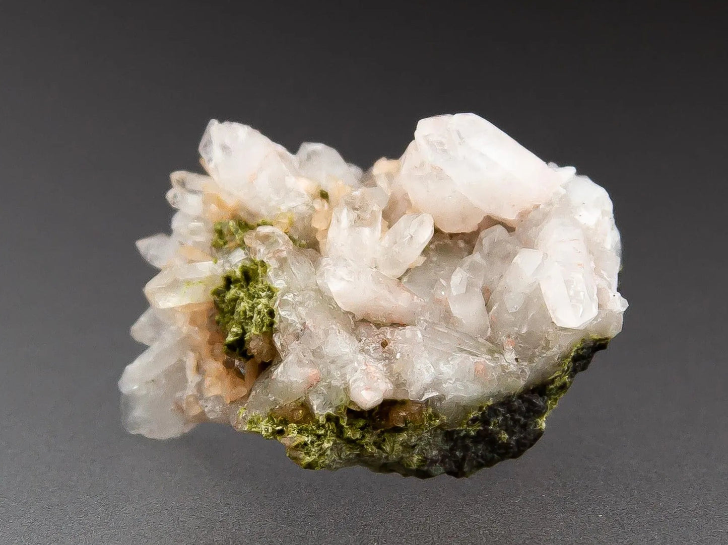 Quartz thumbnail specimen with a dark gray background.