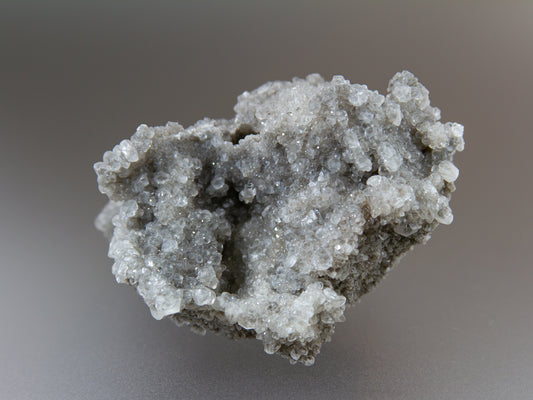 Close-up of a gray crystal formation on a blurred background