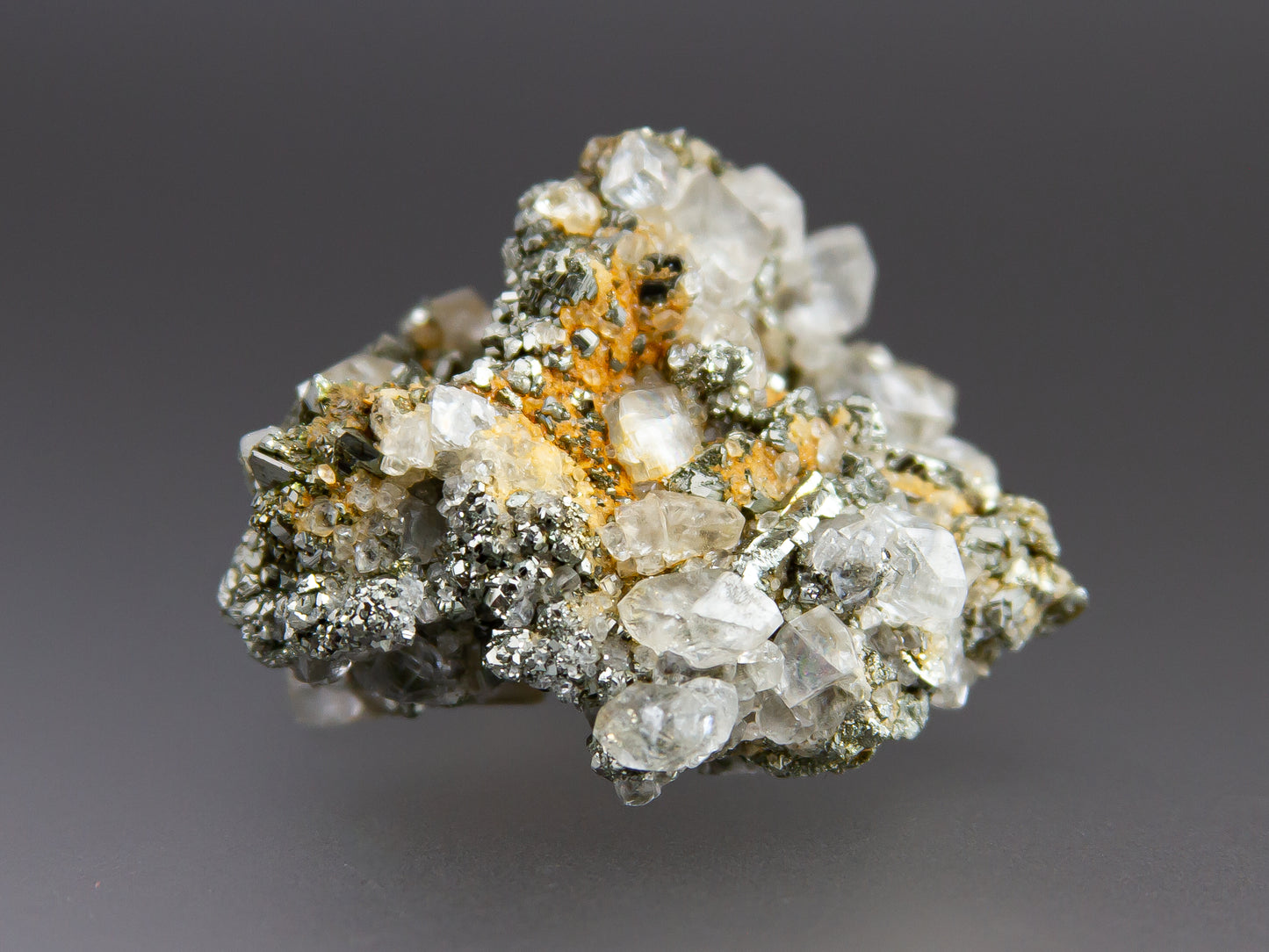 Mineral sample with crystals on a gray background