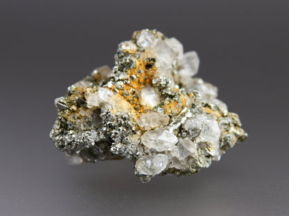 Mineral sample with crystals on a gray background