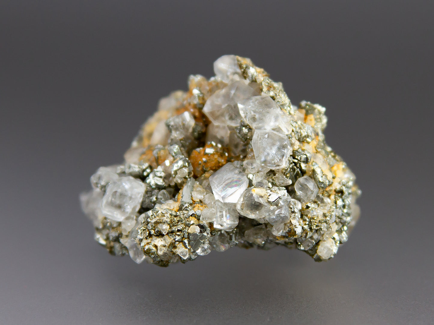 Mineral sample with crystal formations on a gray background