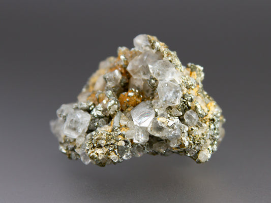 Mineral sample with crystal formations on a gray background