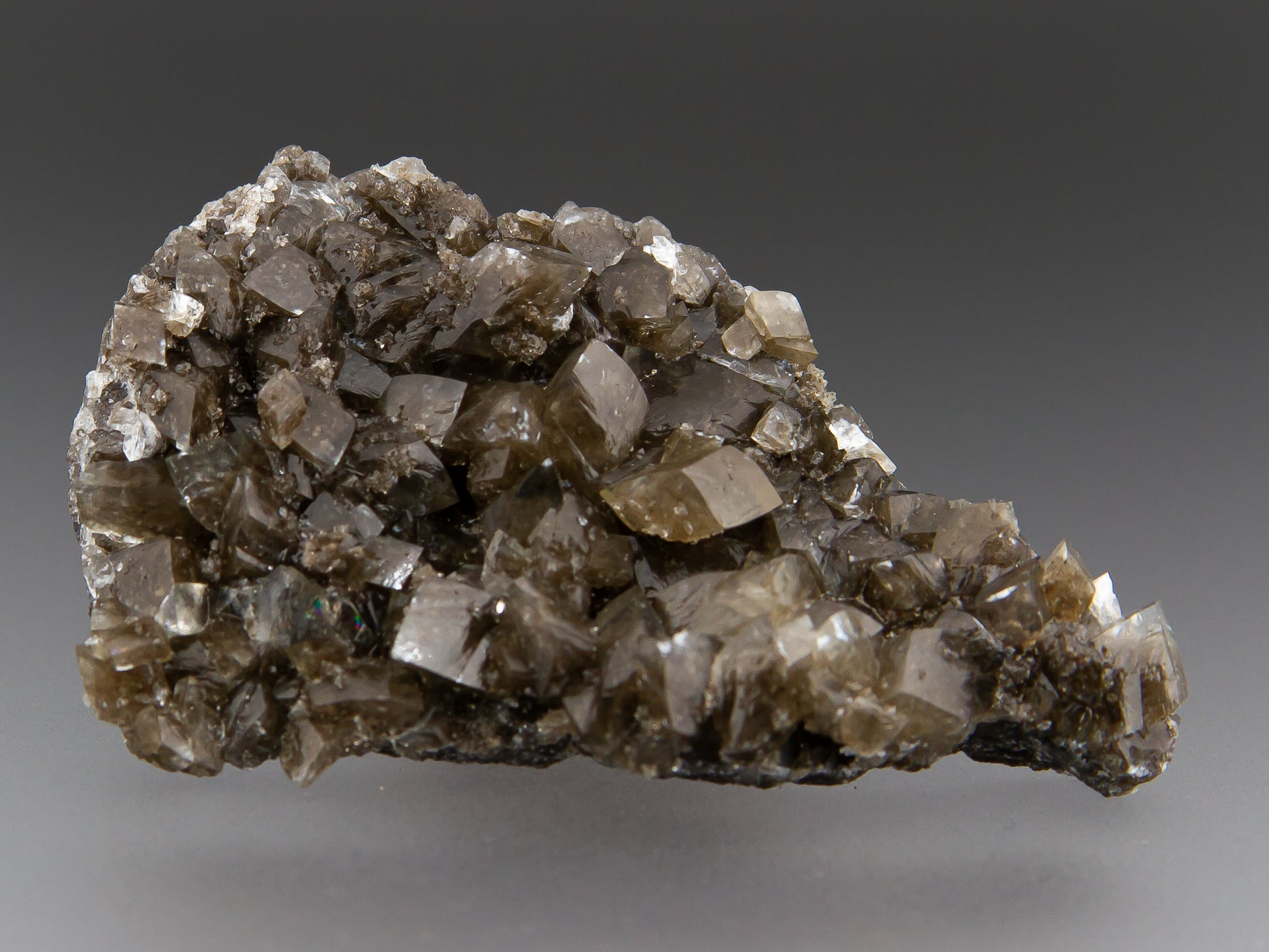 Mineral sample with crystal formations on a gray background
