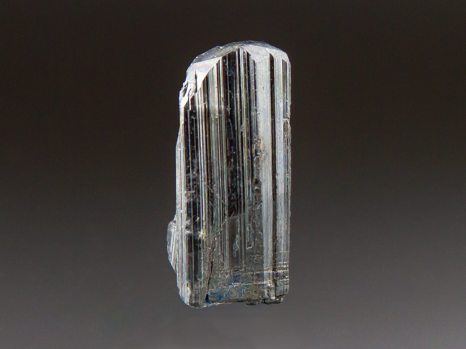 Crystal with layered structure on a dark background