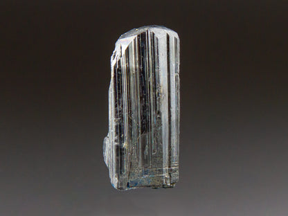 Crystal with layered structure on a dark background